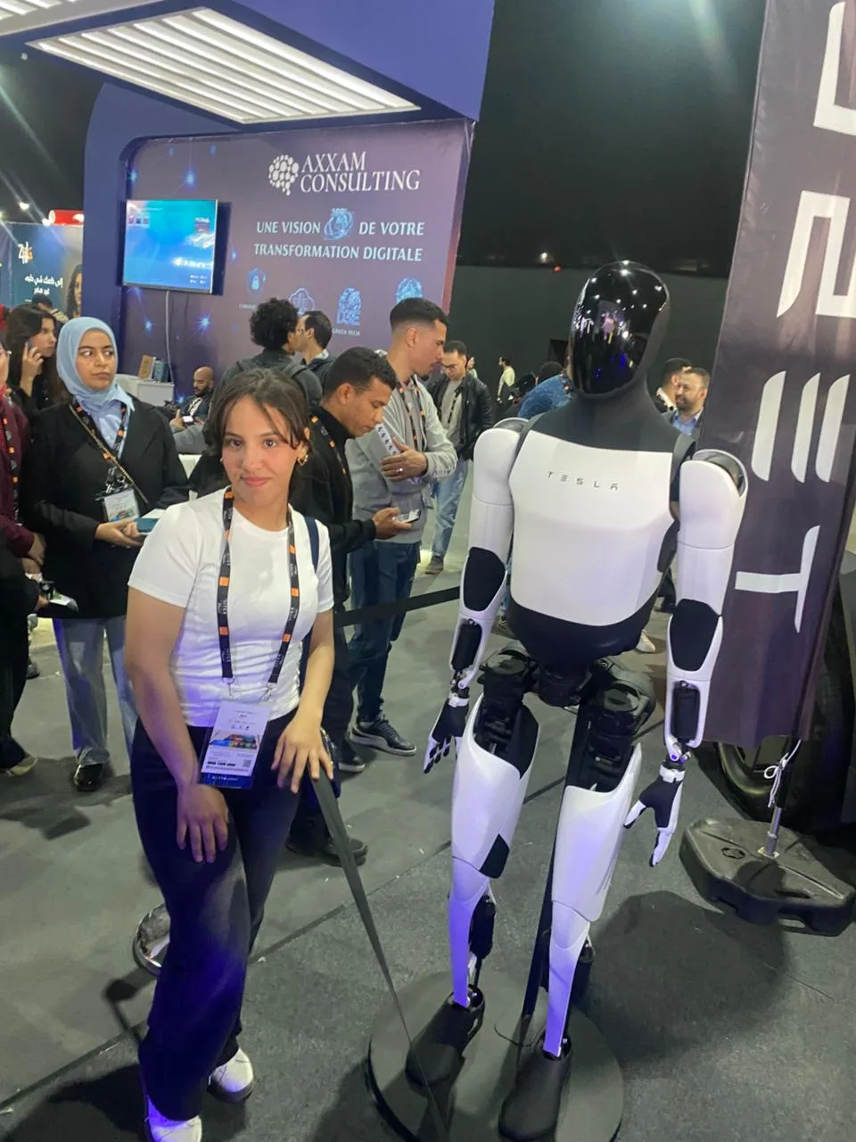 Visitors posing with Tesla Optimus robot at GITEX Africa Marrakech